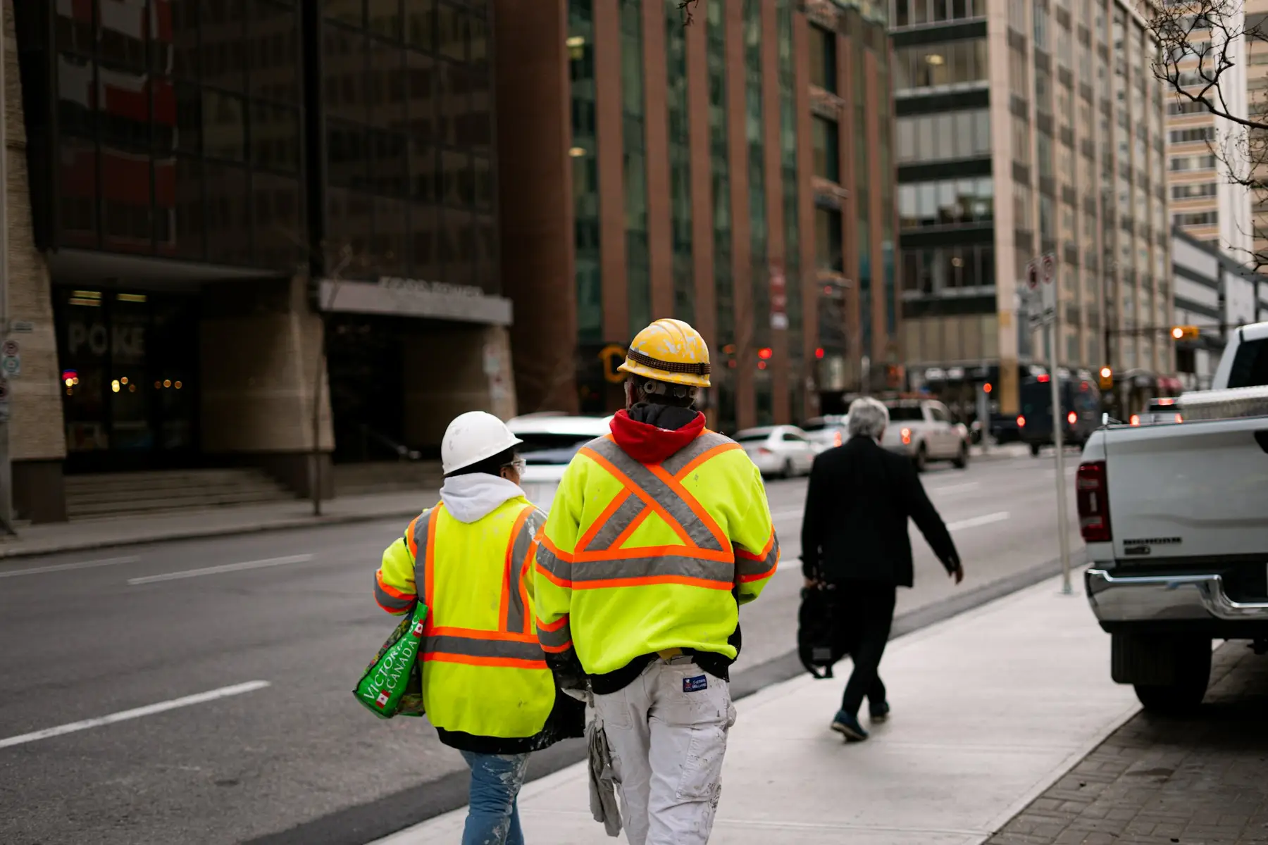 Workers in high-visibility vests in the city