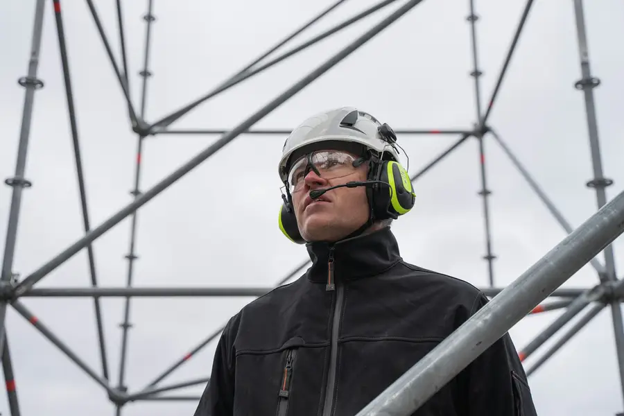 Technician with helmet, goggles and ear defenders